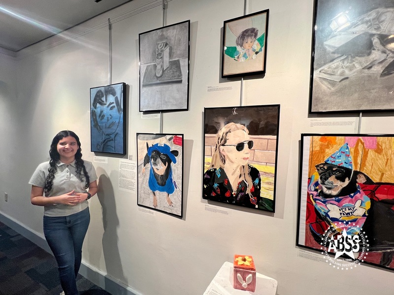 Student showing artwork in gallery at Paramount Theater