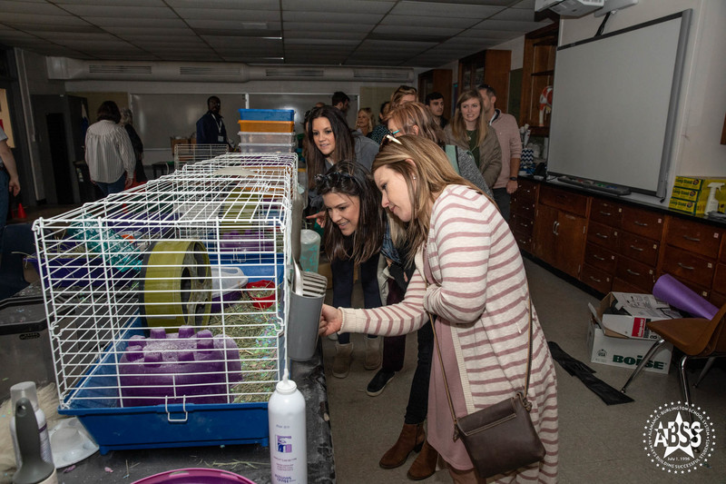 Leadership Alamance participants viewing hamsters in cages at Southern High School.
