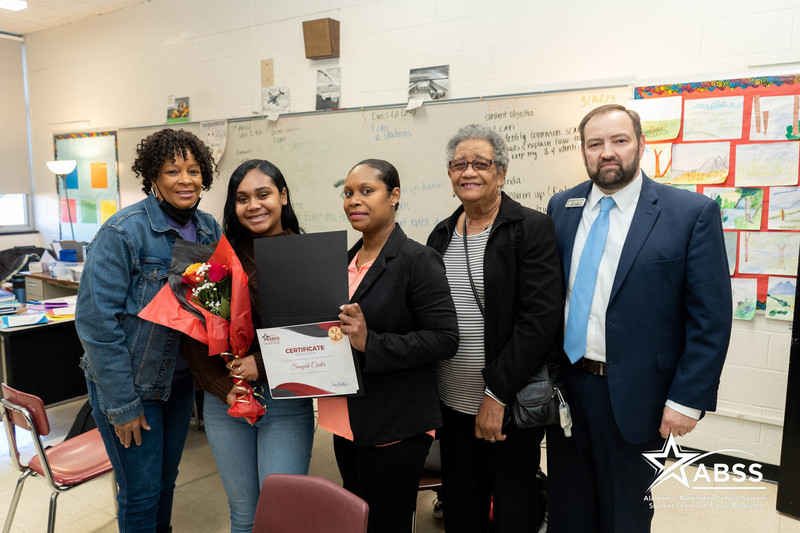 Sanyah Carter with her family and Dr. Butler.  