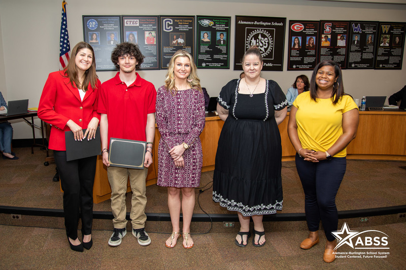 Photograph of Braylee Carter, Kayly Tran, Caleb Hackney, Jaziah Ruffin, and Teauna Thomas from Eastern Alamance High School's FCCLA Club standing side-by-side at a board meeting