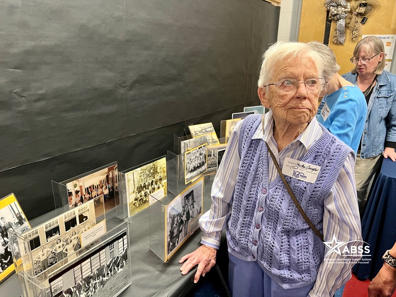 Martha Covington looking at old photos from the school's past 